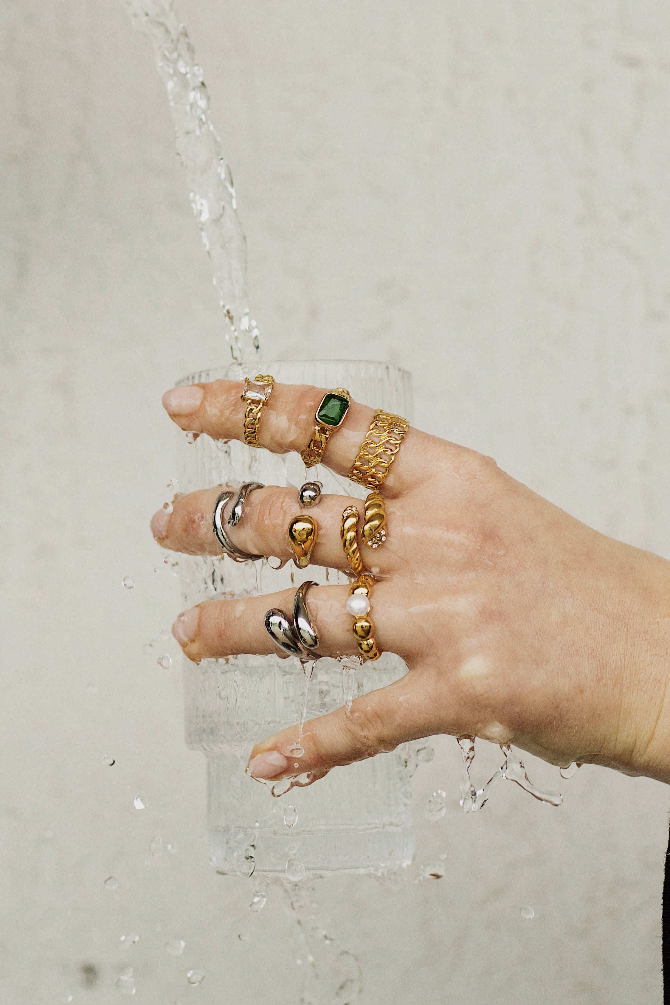 First Slide - Wet hand full of waterproof earrings