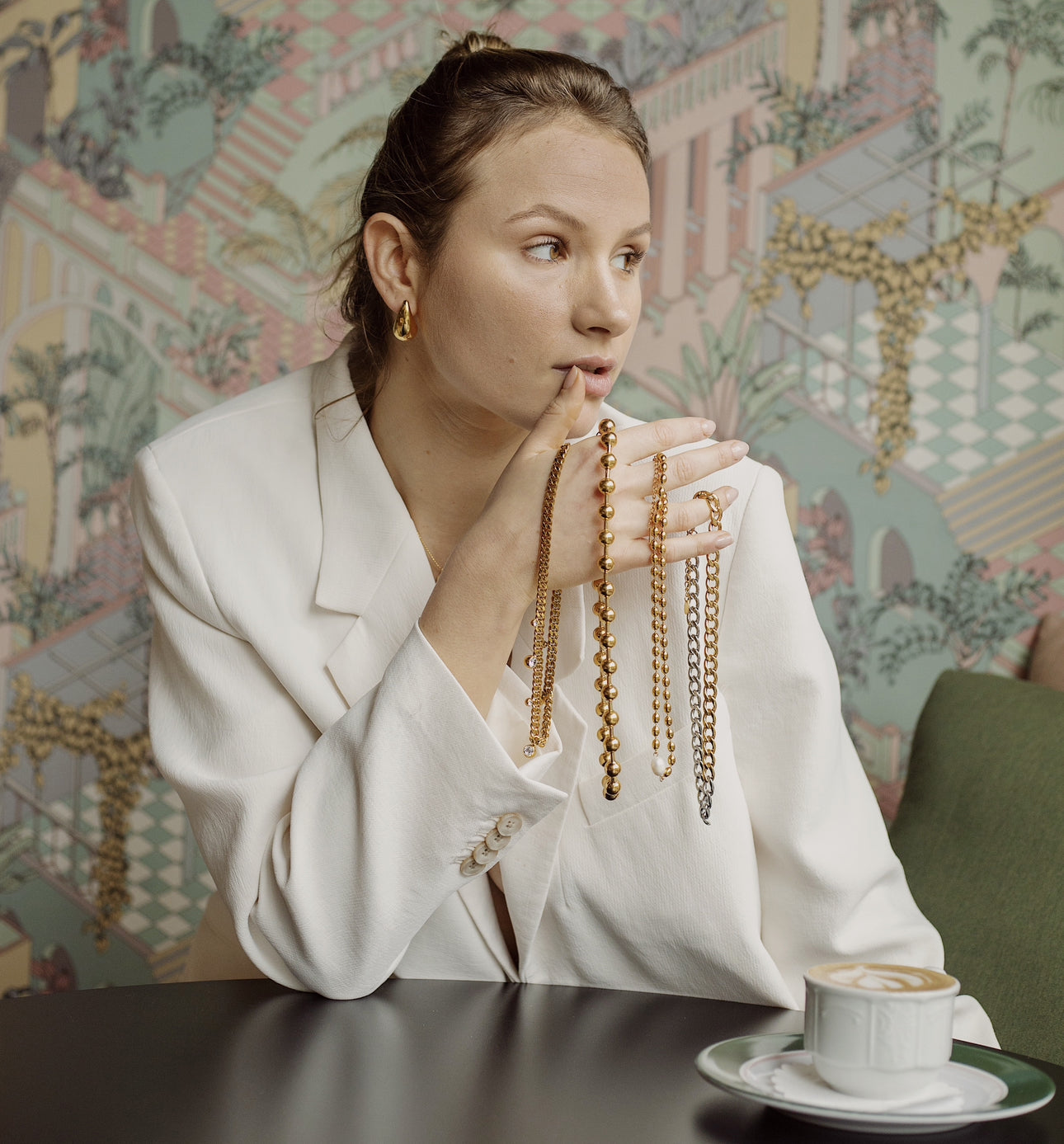 Second Slide - Model in context showing necklaces and drinking Coffee