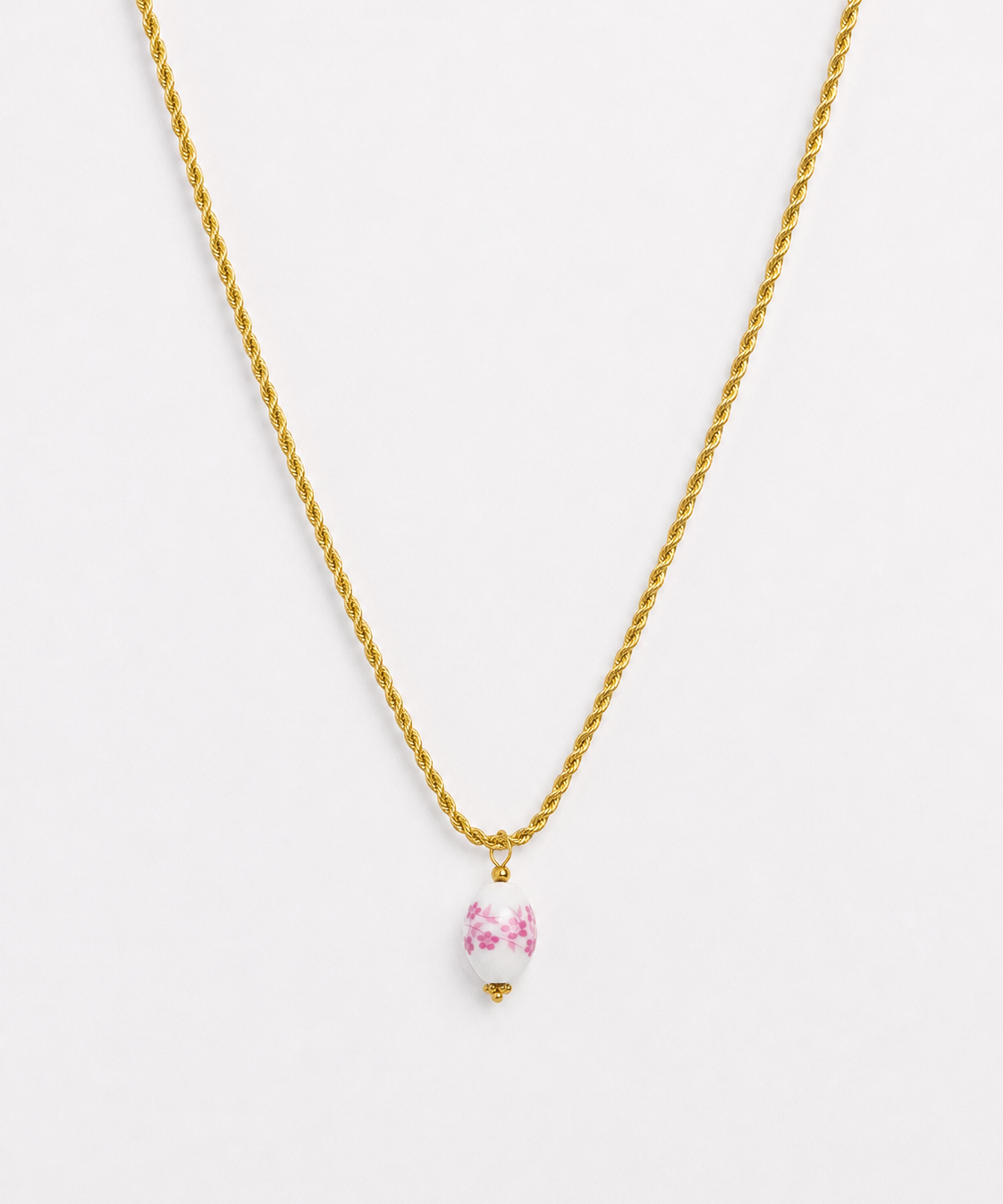 Gold rope chain necklace with pink floral porcelain bead pendant