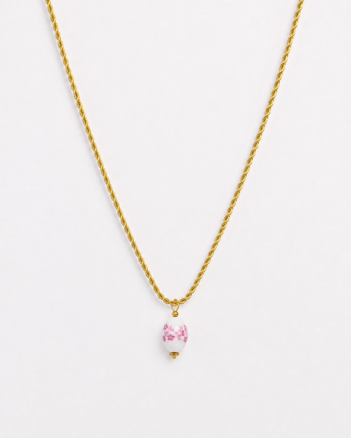 Gold rope chain necklace with pink floral porcelain bead pendant