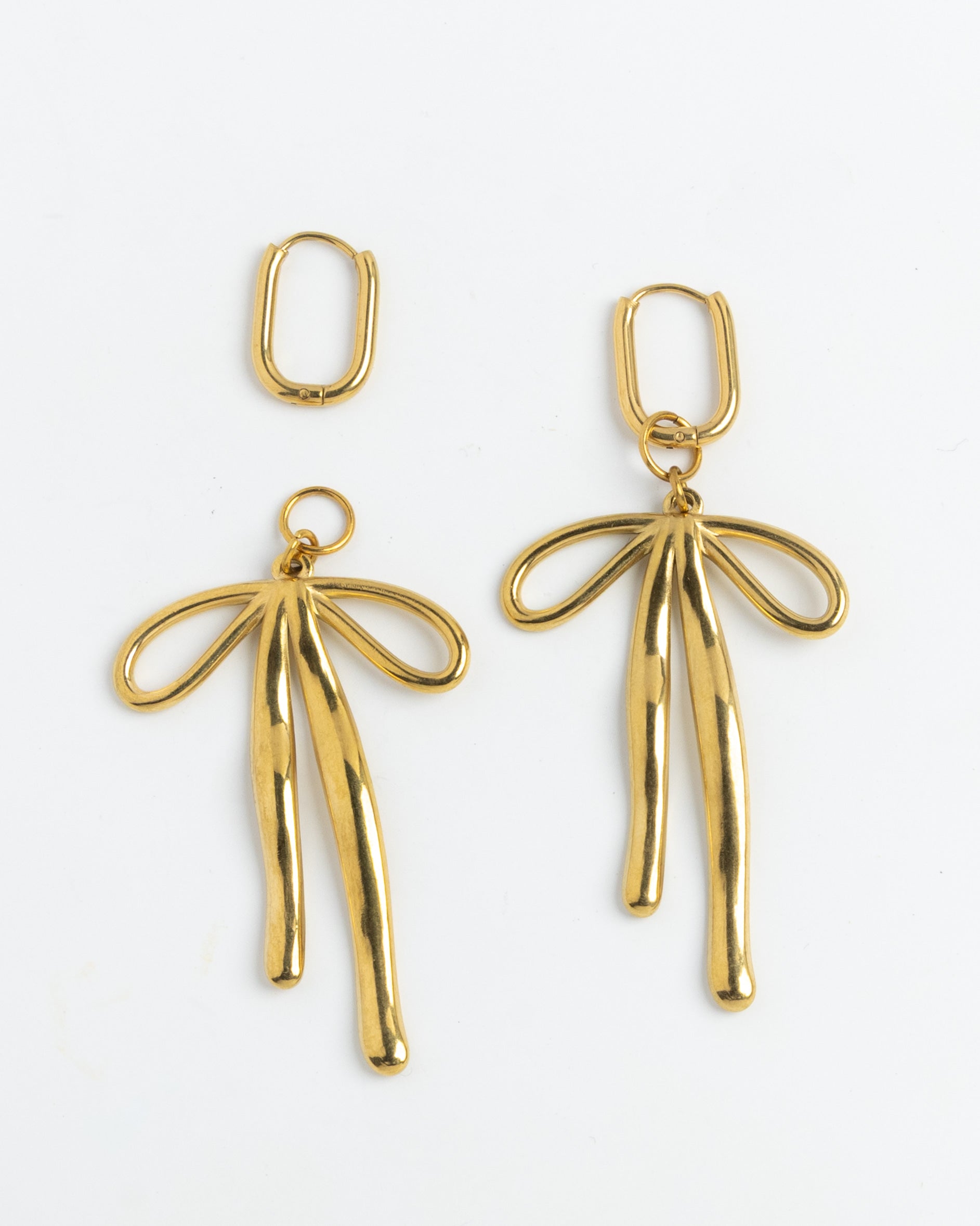 Gold bow charm drop earrings on hinged hoops