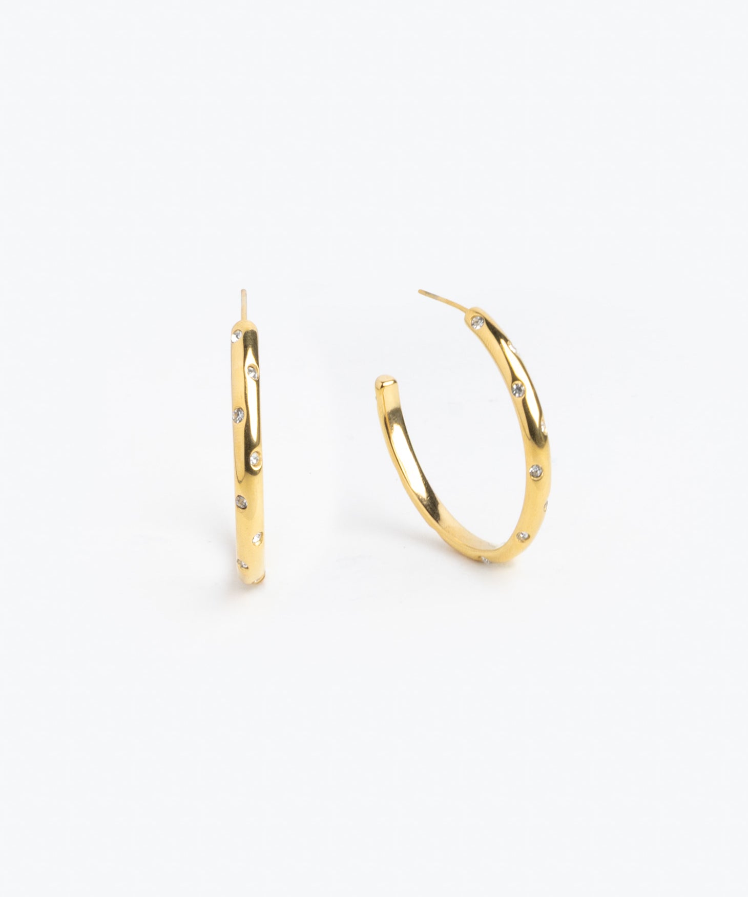 Gold hoop earrings scattered with multicolor gemstones