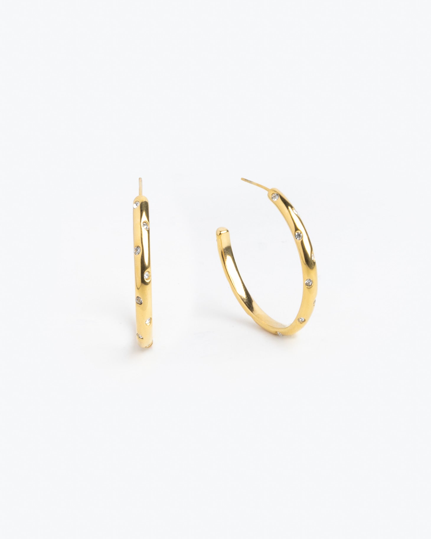 Gold hoop earrings scattered with multicolor gemstones