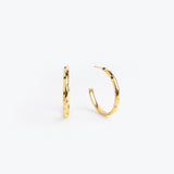 Gold hoop earrings scattered with clear crystal accents