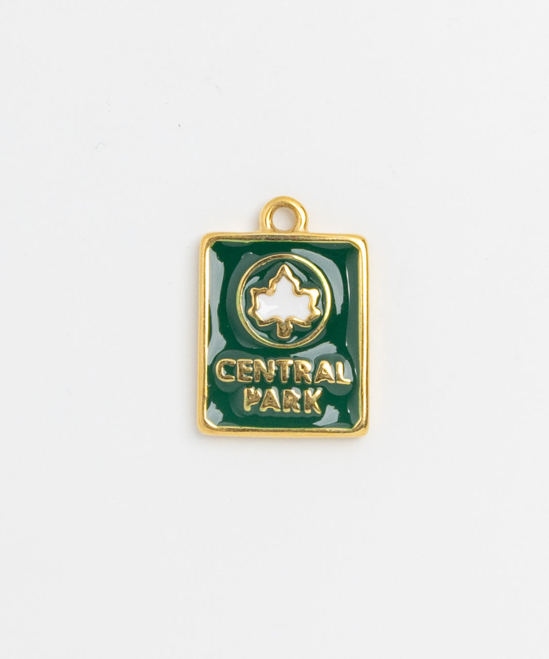 Green enamel Central Park charm with white leaf emblem