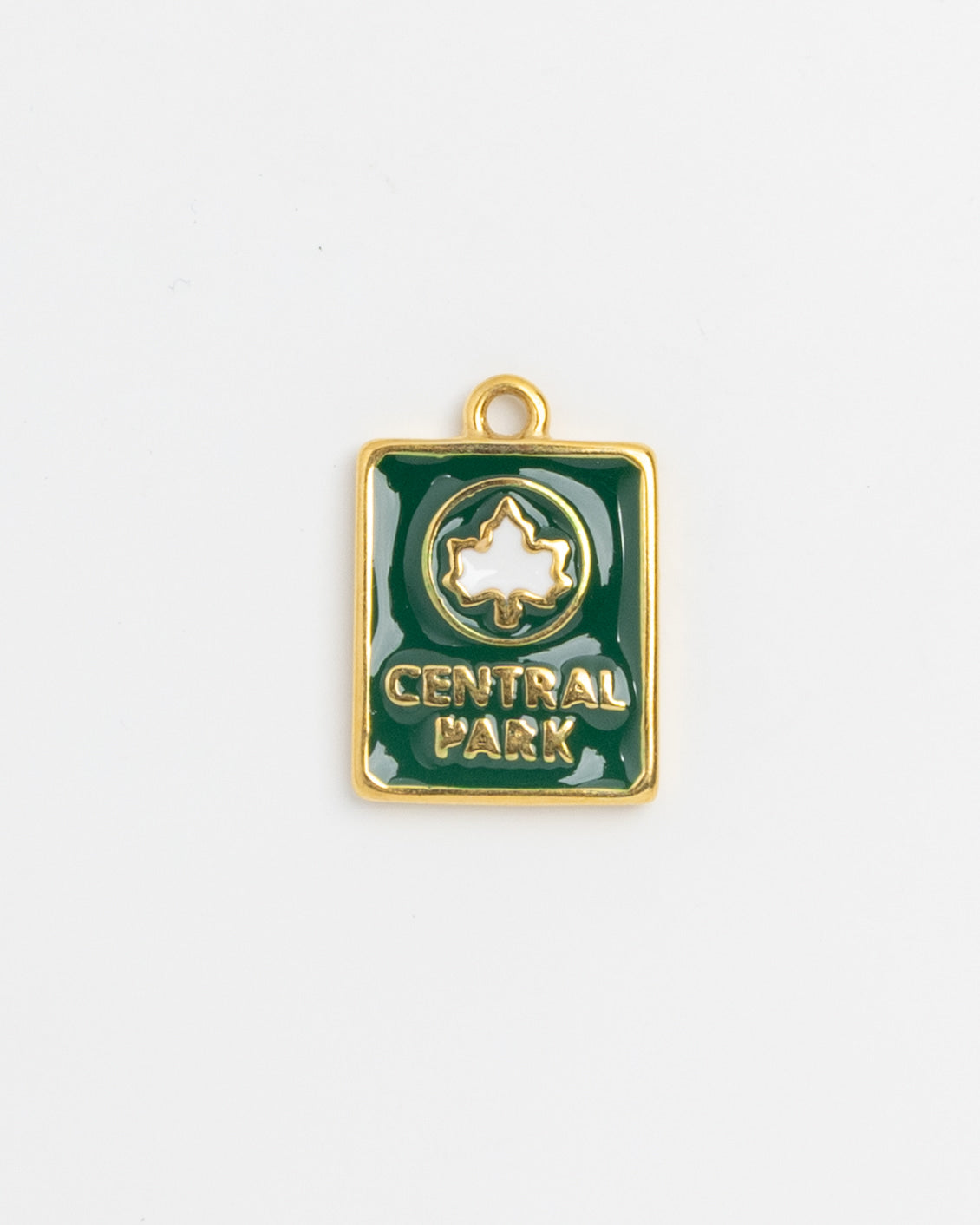 Green enamel Central Park charm with white leaf emblem