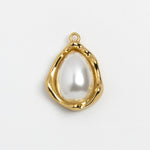 A gold teardrop-shaped pendant featuring a smooth, lustrous white faux pearl in the center, set against a plain light gray background.