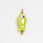 A small glossy lime green fish-shaped charm with a single large white eye and gold-tone metal loop at the top, shown on a plain white background.