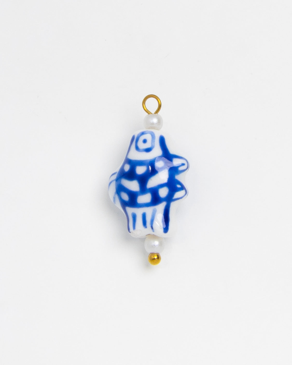 A small decorative bead or charm with a white base, blue hand-drawn style fish pattern, and gold-tone loop and bead accents, shown on a plain white background.